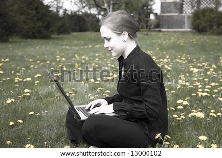 Young Woman Working On Computer In The Garden