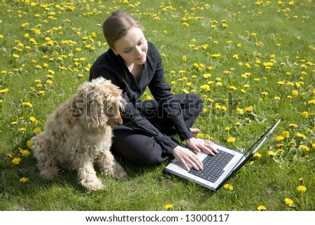 Young Woman And Dog Working On Computer Together