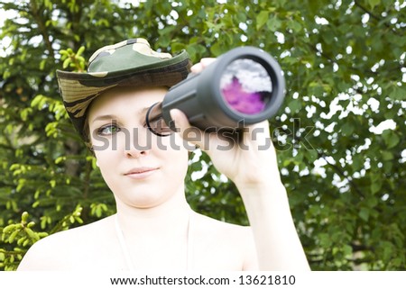 Woman searching with binocular in her hands