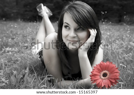 Beauty Smiling Young Women With Red Flower Laying On The Grass