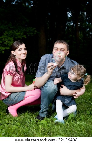 Father Blowing Soap Bubbles. Family Portrait.