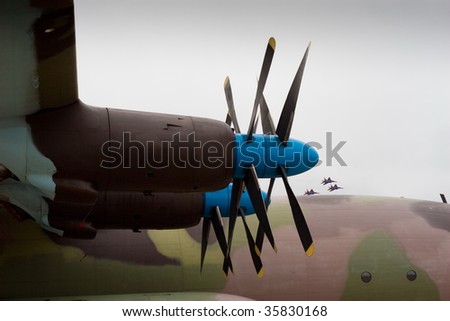 Military Plane Propeller Engines With Flying Fighters On Background