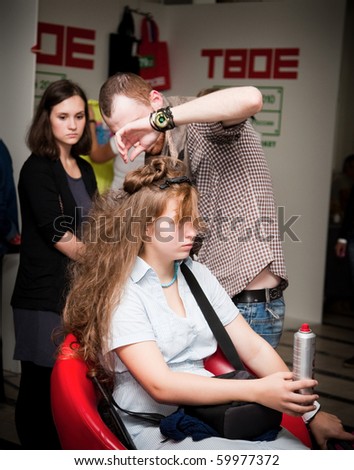 MOSCOW - AUGUST 29: Stylist work on woman hair. Designer market 