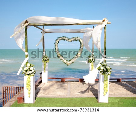 stock photo Wedding arch with flowers decoration on the beach