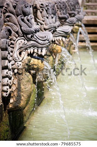 Thermal water is released from the mouth of statues at a hot springs in Banjar, Bali, Indonesia