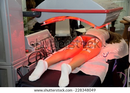 MOSCOW - OCTOBER 24: Cosmetologist performs an infrared sauna at the international exhibition of professional cosmetics and beauty salon equipment INTERCHARM on October 24, 2014 in Moscow