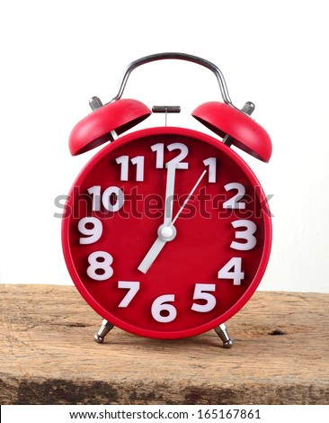 red alarm clock, showing time