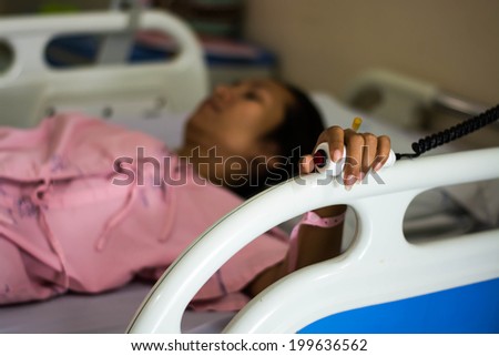 hand pushing nurse call button