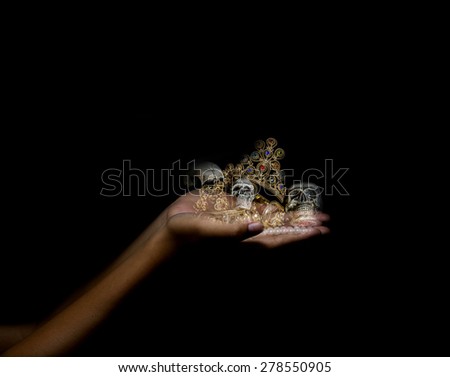Holding hand treasure with skull