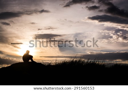 Sad boy silhouette worried on the meadow at sunset ,Silhouette concept