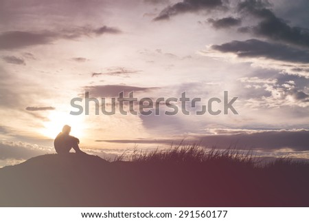 Sad boy silhouette worried on the meadow at sunset ,Silhouette concept