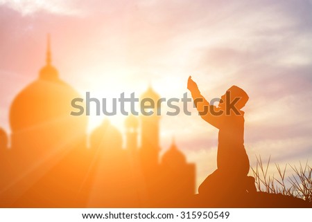 Silhouette muslim boy praying faith in allah God of islam supremely.