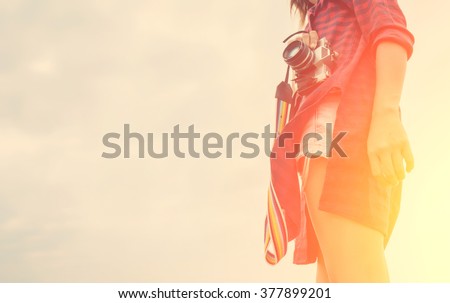 Vintage of beautiful women photography standing hand holding retro camera with sunrise,dream soft style