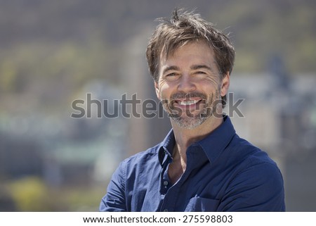 Portrait Of A Mature Active Man Smiling At The Camera