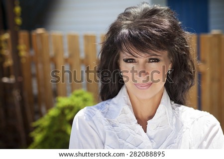 Mature Woman Smiling At The Camera. She is a mother and a successful woman