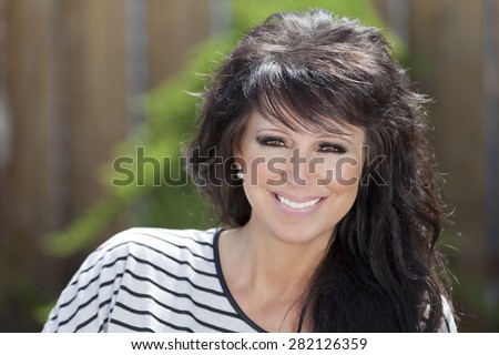 Mature Woman Smiling At The Camera. She is a mother and a successful woman