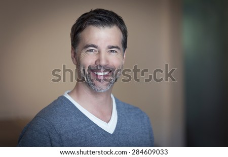 Close-up of a mature man smiling at home
