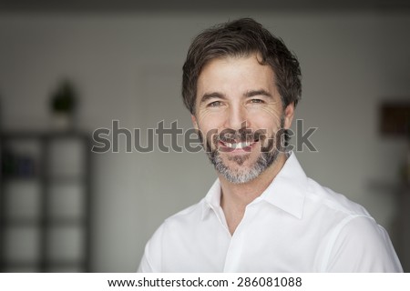Close Up Of A Mature Man Smiling At The Camera
