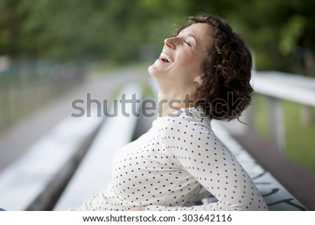 Portrait Of A Pretty Woman Laughing At The Park
