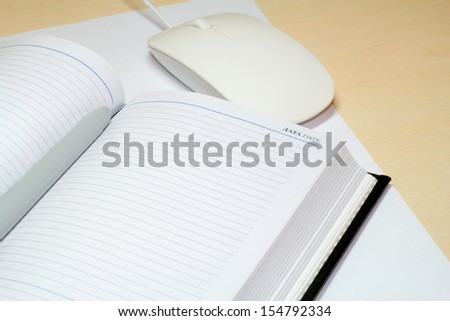 memo pad and a computer mouse on the desk