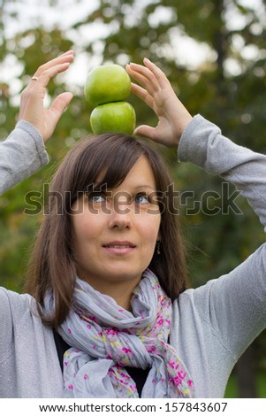 girl thinks about healthy eating in the autumn park