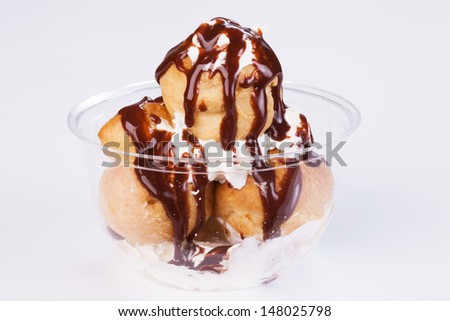 Cream puffs filled with pastry cream and covered with chocolate.Take away food.
