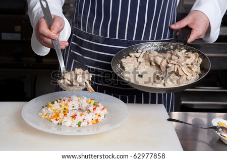 Chef add meat to risotto