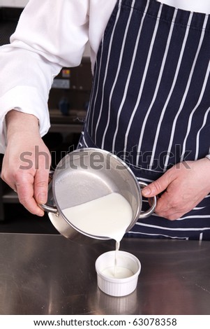 Chef pouring milk in a cup