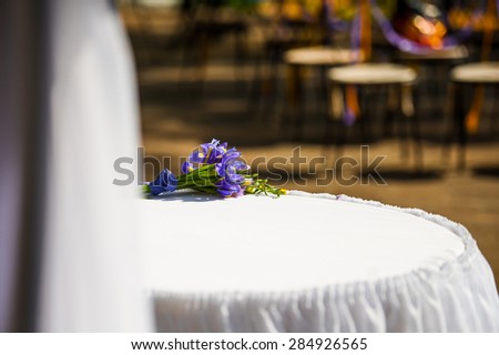 wedding bouquet of purple flowers on a white table