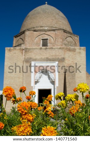 Ancient mausoleum of Islamic religious leader in Samarkand part of Central Asia with marigolds in foreground