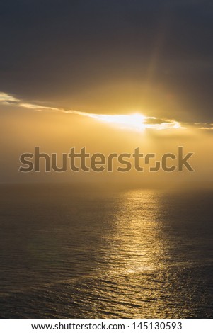 Golden cloudy sunset at seaside