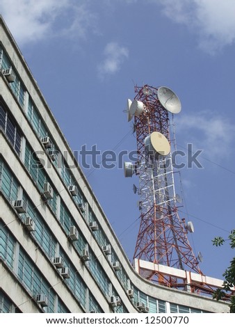 Communications Tower over a building, in a summer day