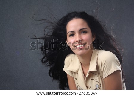 Beautiful caucasian girl smiling with blowing up hair