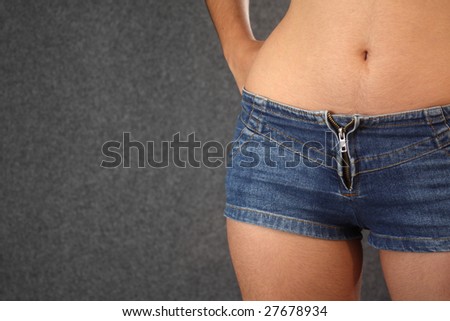 Sexy shot of a girl's waist, in a short jeans