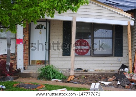ST. LOUIS-APRIL 24: Homes display DO NOT ENTER signs warning residents that their homes are in an unsafe condition from tornados in St. Louis on Good Friday, April 24, 2011.