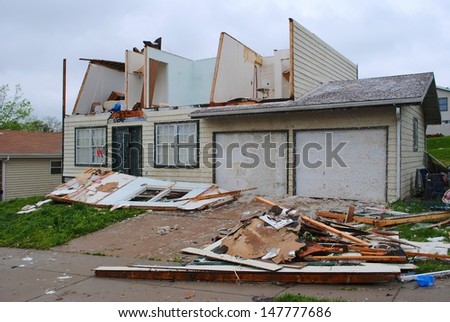 ST. LOUIS-APRIL 24: Debris covers a driveway and second floor rooms are exposed of a local residentÃ?Â¢??s home after being hit by a tornado in St. Louis on Good Friday, April 24, 2011.