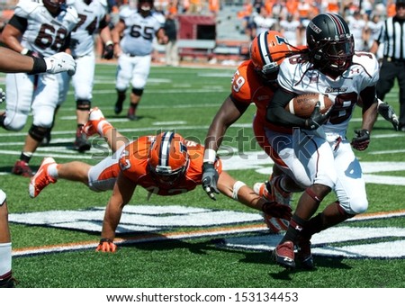 CHAMPAIGN,IL-AUGUST 31: Illinois linebacker Mason Monheim (43) reaches for SIU running back Tay Willis (18) at the Illini 20 yard line during the 4th quarter of a game on Saturday, Aug 31, 2013.