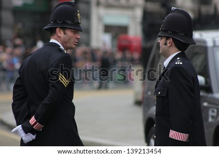 LONDON - APRIL 17: Two police officers talk outside the funeral service for Margaret Thatcher at St. Paul\'s Cathedral on April 17, 2013 in London.