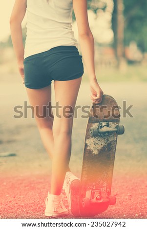 Beautiful skater girl in summer city