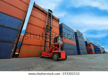 Crane lifter handling container box loading to truck in import export zone
