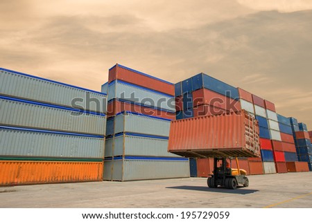 Forklift handling container box loading to truck in import export  zone