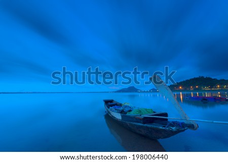 Fishing boat beached with blue view