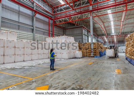 foreman control  the worker driving a forklift loader in warehouse with load jumbo bag