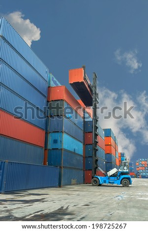 Crane lifter handling container box loading to truck in import export zone