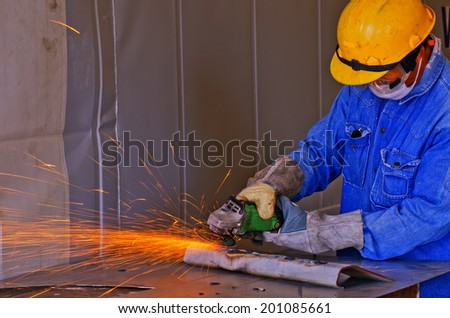 manual worker work in factory with grinder