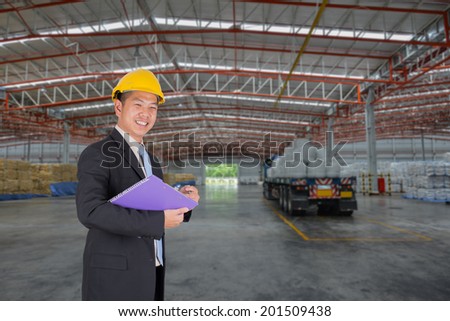 Manager asian business at happy complete job in warehouse