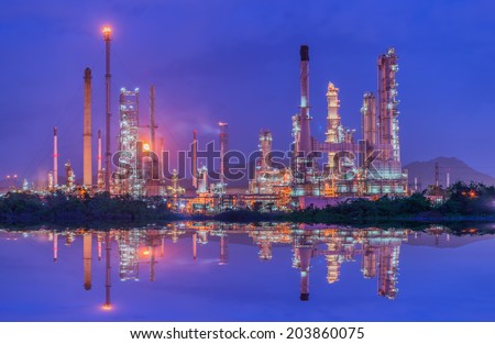 Oil refinery at twilight - petrochemical industry with water reflect
