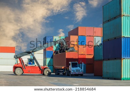 Crane lifter handling container box loading to truck in import export