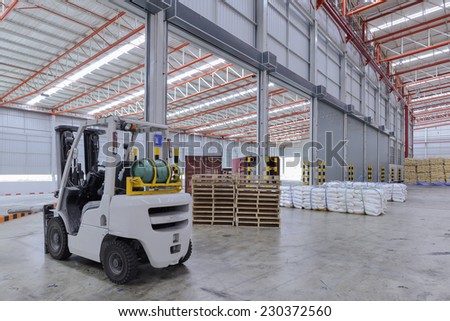 Warehouse laborer team at unloading works with forklift loader