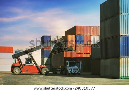 Crane lifter handling container box loading to truck in import export